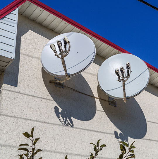Satellite dish mounted on an insulated house façade